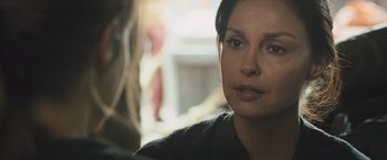 Movie still from “Divergent” (2014), directed by Neil Burger – A person sitting down looking at the camera; Close Up shot, Over the shoulder angle