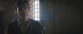 Movie still from “Divergent” (2014), directed by Neil Burger – A person wearing glasses; Close Up shot, Over the shoulder angle