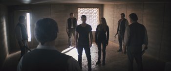 Movie still from “Divergent” (2014), directed by Neil Burger – A group of people standing around in a room; Wide shot, Over the shoulder angle