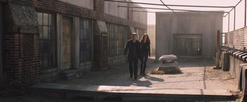 Movie still from “Divergent” (2014), directed by Neil Burger – A man and a woman walking down a street; Wide shot, High angle