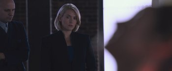 Movie still from “Divergent” (2014), directed by Neil Burger – A woman with blonde hair wearing a black jacket; Medium shot, Over the shoulder angle