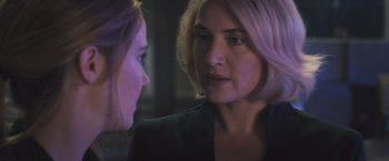 Movie still from “Divergent” (2014), directed by Neil Burger – Two women talking to each other in the dark; Close Up shot, Over the shoulder angle