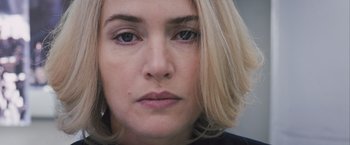 Movie still from “Divergent” (2014), directed by Neil Burger – A woman's face with blonde hair and blue eyes; Close Up shot, Overhead angle