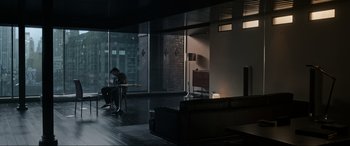 Movie still from “Doctor Strange” (2016), directed by Scott Derrickson – A man sitting at a table in a room with a large window; Extreme Wide shot, High angle