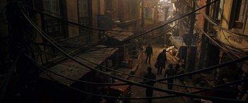 Movie still from “Doctor Strange” (2016), directed by Scott Derrickson – A group of people walking down a street; Extreme Wide shot, High angle