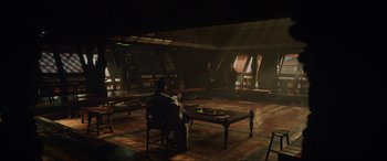 Movie still from “Doctor Strange” (2016), directed by Scott Derrickson – A man sitting on a chair in a room; Wide shot, High angle
