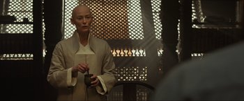 Movie still from “Doctor Strange” (2016), directed by Scott Derrickson – A person holding a bowl in a room; Medium shot, Over the shoulder angle