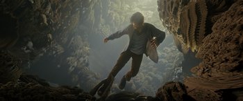 Movie still from “Doctor Strange” (2016), directed by Scott Derrickson – A man is jumping in the air while holding a surfboard; Wide shot, Overhead angle