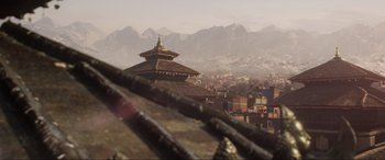 Movie still from “Doctor Strange” (2016), directed by Scott Derrickson – A view of a city from a distance with mountains in the background; Extreme Wide shot, High angle