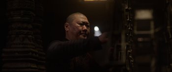 Movie still from “Doctor Strange” (2016), directed by Scott Derrickson – A man is pointing at something in a dark room; Close Up shot, Low angle