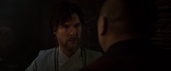 Movie still from “Doctor Strange” (2016), directed by Scott Derrickson – A man with a beard looking into a mirror; Close Up shot, Over the shoulder angle