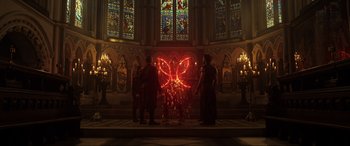Movie still from “Doctor Strange” (2016), directed by Scott Derrickson – Three people standing in front of a stained glass window; Extreme Wide shot, High angle