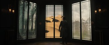 Movie still from “Doctor Strange” (2016), directed by Scott Derrickson – A woman standing in front of a window looking out at a desert; Wide shot, Low angle