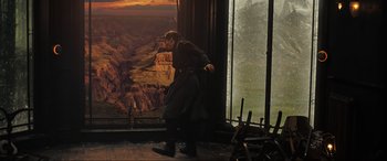 Movie still from “Doctor Strange” (2016), directed by Scott Derrickson – A man standing in front of a large window; Wide shot, Over the shoulder angle
