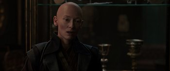 Movie still from “Doctor Strange” (2016), directed by Scott Derrickson – A man with bald head looking into the distance; Close Up shot, Over the shoulder angle