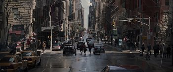 Movie still from “Doctor Strange” (2016), directed by Scott Derrickson – A street scene with cars and people crossing the street; Extreme Wide shot, High angle