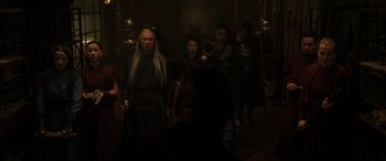 Movie still from “Doctor Strange” (2016), directed by Scott Derrickson – A group of people standing in a room with swords; Medium shot, Over the shoulder angle