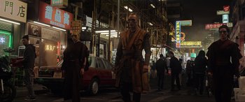 Movie still from “Doctor Strange” (2016), directed by Scott Derrickson – A man dressed as a monk walking down the street; Wide shot, Low angle