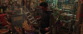 Movie still from “Doctor Strange” (2016), directed by Scott Derrickson – A man is cooking something on a fire pit; Medium shot, High angle