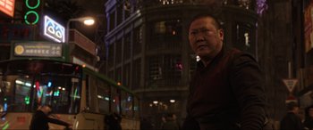 Movie still from “Doctor Strange” (2016), directed by Scott Derrickson – A man standing in front of a building at night; Medium shot, Low angle