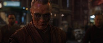 Movie still from “Doctor Strange” (2016), directed by Scott Derrickson – A person with a face painting; Close Up shot, Over the shoulder angle