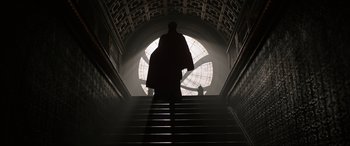 Movie still from “Doctor Strange” (2016), directed by Scott Derrickson – A man walking up a set of stairs; Wide shot, Low angle