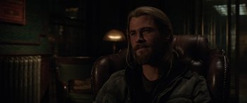 Movie still from “Doctor Strange” (2016), directed by Scott Derrickson – A person sitting in a chair wearing headphones; Close Up shot, Over the shoulder angle