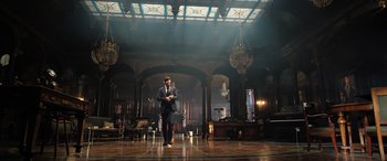 Movie still from “Doctor Strange in the Multiverse of Madness” (2022), directed by Sam Raimi – A man in a suit and hat standing in a room; Extreme Wide shot, Low angle