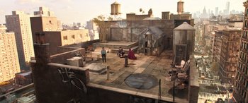 Movie still from “Doctor Strange in the Multiverse of Madness” (2022), directed by Sam Raimi – Two people are sitting on a roof on a building; Extreme Wide shot, High angle