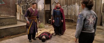 Movie still from “Doctor Strange in the Multiverse of Madness” (2022), directed by Sam Raimi – A group of men standing next to each other in a room; Medium shot, High angle