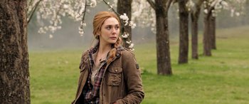 Movie still from “Doctor Strange in the Multiverse of Madness” (2022), directed by Sam Raimi – A woman standing in front of a tree in a field; Medium shot, Over the shoulder angle