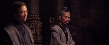 Movie still from “Doctor Strange in the Multiverse of Madness” (2022), directed by Sam Raimi – An old man with a beard and a long hair bun; Close Up shot, Over the shoulder angle
