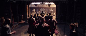 Movie still from “Doctor Strange in the Multiverse of Madness” (2022), directed by Sam Raimi – A group of people standing in front of a stage; Wide shot, Low angle