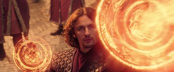 Movie still from “Doctor Strange in the Multiverse of Madness” (2022), directed by Sam Raimi – A person holding a sword; Medium shot, Over the shoulder angle