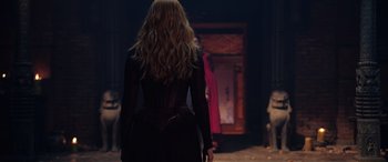 Movie still from “Doctor Strange in the Multiverse of Madness” (2022), directed by Sam Raimi – A woman with long blonde hair standing in front of a doorway; Medium shot, Over the shoulder angle