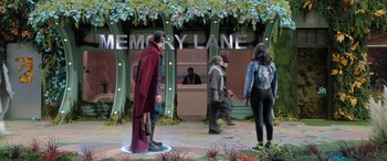 Movie still from “Doctor Strange in the Multiverse of Madness” (2022), directed by Sam Raimi – A group of people standing in front of a building; Wide shot, Over the shoulder angle