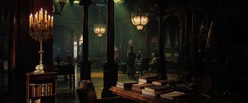 Movie still from “Doctor Strange in the Multiverse of Madness” (2022), directed by Sam Raimi – A group of people sitting in a room with tables; Extreme Wide shot, High angle