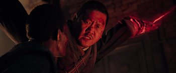 Movie still from “Doctor Strange in the Multiverse of Madness” (2022), directed by Sam Raimi – A man with blood all over his face and neck; Close Up shot, Over the shoulder angle