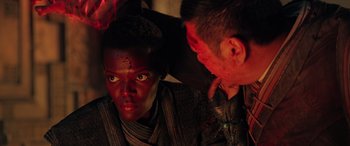 Movie still from “Doctor Strange in the Multiverse of Madness” (2022), directed by Sam Raimi – A person with a blood covered face is looking at another person with blood on their face; Close Up shot, Over the shoulder angle