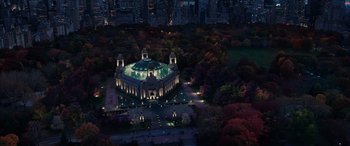 Movie still from “Doctor Strange in the Multiverse of Madness” (2022), directed by Sam Raimi – An aerial view of a building lit up at night; Extreme Wide shot, High angle