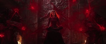 Movie still from “Doctor Strange in the Multiverse of Madness” (2022), directed by Sam Raimi – A woman sitting in the middle of a red room; Wide shot, Low angle