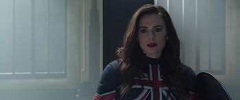 Movie still from “Doctor Strange in the Multiverse of Madness” (2022), directed by Sam Raimi – A woman in a union jack outfit standing in front of a window; Close Up shot, Over the shoulder angle