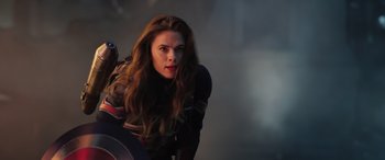 Movie still from “Doctor Strange in the Multiverse of Madness” (2022), directed by Sam Raimi – A woman with long brown hair is standing next to a man; Medium shot, Over the shoulder angle