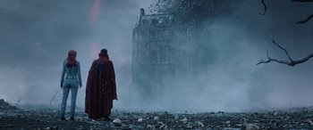 Movie still from “Doctor Strange in the Multiverse of Madness” (2022), directed by Sam Raimi – A man in a red robe standing in front of a building; Wide shot, Low angle