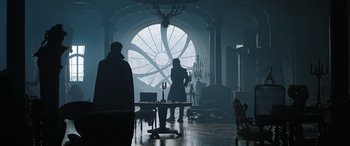 Movie still from “Doctor Strange in the Multiverse of Madness” (2022), directed by Sam Raimi – Two people are standing in front of a large window; Wide shot, Over the shoulder angle