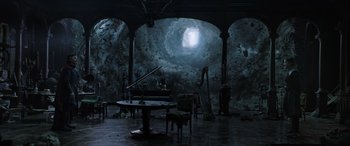 Movie still from “Doctor Strange in the Multiverse of Madness” (2022), directed by Sam Raimi – A dark room with a piano and a harp; Extreme Wide shot, High angle