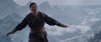 Movie still from “Doctor Strange in the Multiverse of Madness” (2022), directed by Sam Raimi – An asian man in traditional garb standing in the snow; Medium shot, Low angle