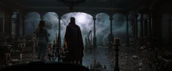 Movie still from “Doctor Strange in the Multiverse of Madness” (2022), directed by Sam Raimi – A man in a red robe standing in front of candles; Wide shot, Low angle