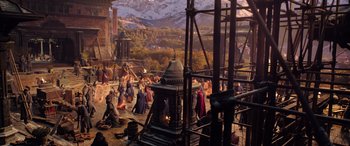 Movie still from “Doctor Strange in the Multiverse of Madness” (2022), directed by Sam Raimi – A group of people standing around a fire place; Extreme Wide shot, High angle