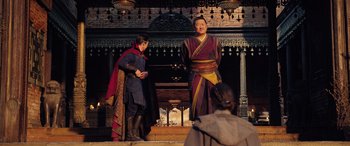 Movie still from “Doctor Strange in the Multiverse of Madness” (2022), directed by Sam Raimi – Two men dressed in medieval garb standing in front of a fireplace; Medium shot, Over the shoulder angle